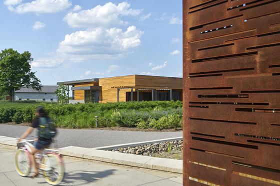 Photo of a student riding a bike on Eden Hall Campus